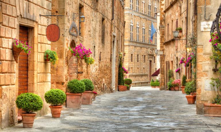 Picturesque street with flowers and historic architecture.